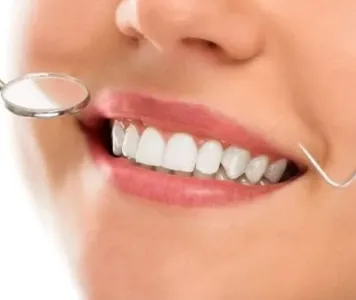 A woman has a regular dental checkup focusing on teeth whitening and dental cosmetic procedures.